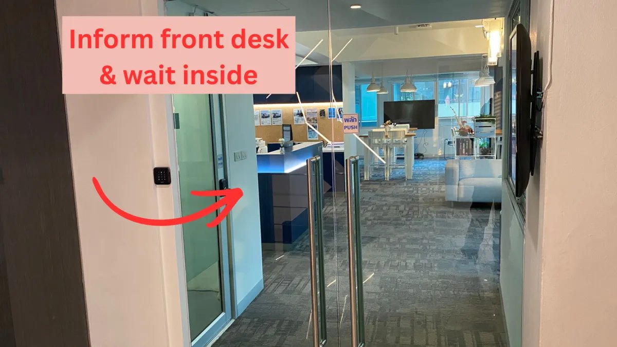 The HQ reception desk on the 4th floor, seen through the glass doors